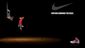 Nike Basketball Player Dunks A Basketball In The Dark Wallpaper