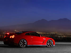 Nissan Skyline Gtr R35 City And Mountain View Wallpaper