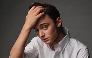 Noah Schnapp Touching His Hair Wallpaper