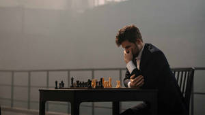 Norwegian Chess Grandmaster Magnus Carlsen Portraying An Expressive Pose During A Game. Wallpaper