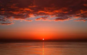 Ocean Under Red Evening Sky Wallpaper