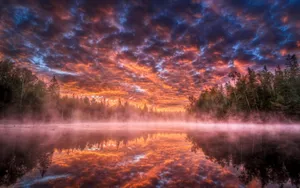 Ominous Clouds Over A Foggy Lake Wallpaper