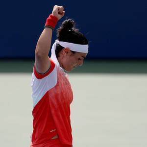 Ons Jabeur Celebrating Victory With Raised Fist Wallpaper