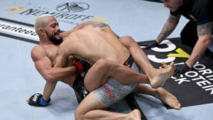 Opponent Tackling Deiveson Figueiredo Wallpaper