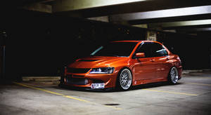 Orange Jdm Car In Parking Lot Wallpaper