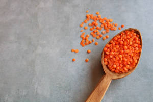 Orange Lentils In Scoop Wallpaper