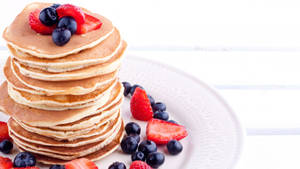 Pancakes Surrounded By Berries Wallpaper