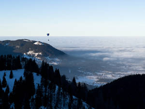 Paragliding Above Snow Mountain In Germany Wallpaper