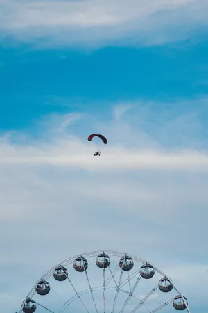 Paragliding Over Ferris Wheel Wallpaper