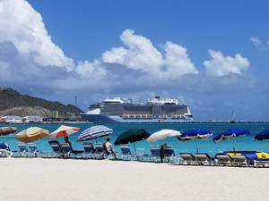 Parasols Lining Up At Sint Maarten Shore Wallpaper