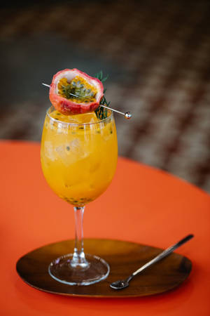 Passion Fruit Cocktail Drink In Wine Glass Wallpaper