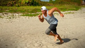 Patrick Rodgers Running On Beach Wallpaper