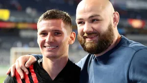 Patryk Klimala Smilingwith Fan Wallpaper