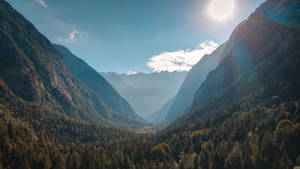 Peaceful Mountainous Valley Slope Wallpaper