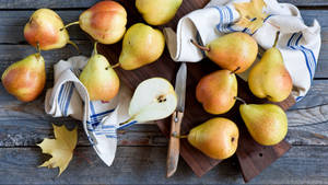 Pear On The Table With Knife Wallpaper