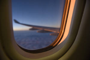 Peek Of The Airplane's Wing From A Plane Window Wallpaper