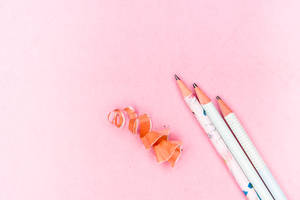 Pencils On Pastel Pink Color Paper Wallpaper