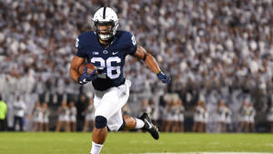 Penn State Football Player Running With The Ball Wallpaper