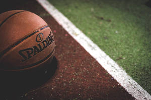 Perfectly Weighted: Tackle Any Court Challenge With A Spalding Basketball Wallpaper