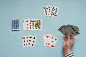 Person Playing Rummy On His Own Wallpaper