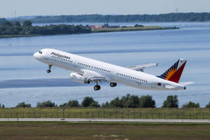 Philippine Airlines Plane Taking Off With Lake View Wallpaper