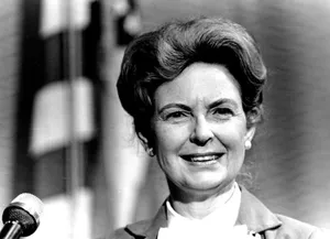 Phyllis Schlafly Delivering A Speech At A Podium Wallpaper