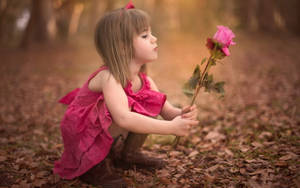 Pink Roses Held By A Little Girl Wallpaper