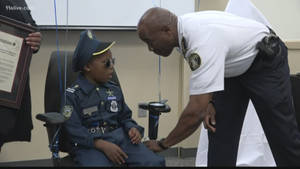 Police Officer Honors Boy Wallpaper