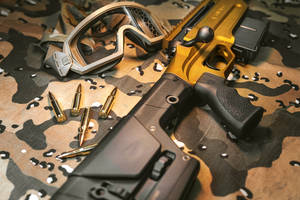 Powerful Intricacy - A Close Up Of A Gun And Bullets Wallpaper