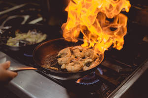 Prawns Flambé On A Wok Pan Wallpaper