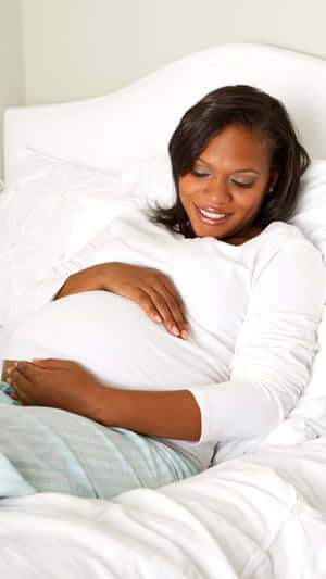 Pregnant Woman Lying In Bed Wallpaper