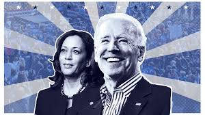 President Joe Biden Delivering A Speech With An American Flag In The Background Wallpaper