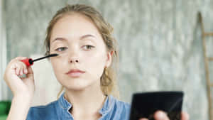 Pretty Teen Girl Doing Makeup Wallpaper