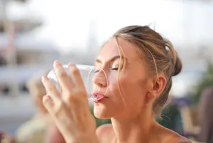 Pretty Woman Drinking Water From Glass Wallpaper