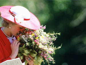 Princess Diana Gracefully Holding A Bouquet Of Flowers Wallpaper