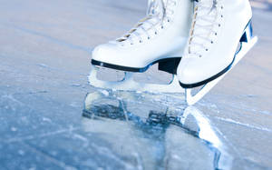 Pristine Ice Skating Boots On Glacial Surface Wallpaper