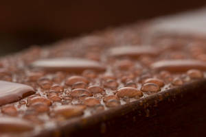 Pristine Water Droplets On Polished Wood Wallpaper