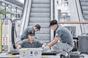 Professional Escalator Technician At Work Wallpaper