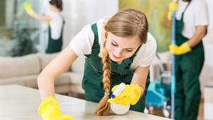 Professional Housekeeper Cleaning Table Wallpaper