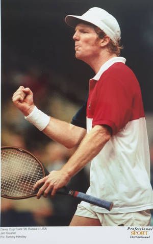 Professional Tennis Player Jim Courier In Action Wallpaper