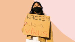 Protester Holding Sign Against Racism Wallpaper