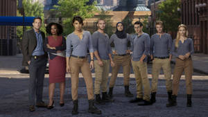 Quantico Tv Series Characters Posing In The Foreground Of Fbi Academy Wallpaper