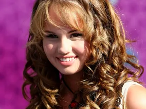 Radiant Teenager With Curls Wallpaper