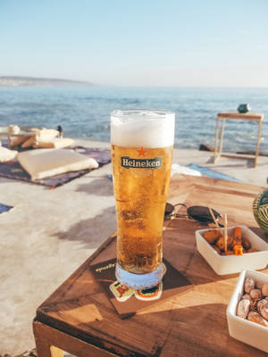 Raise A Glass Of Heineken Beer With Friends And Make It A Night To Remember Wallpaper