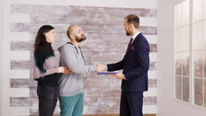 Real Estate Agent Handshake With Clients Wallpaper