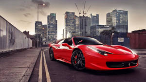 Red Ferrari Sitting On A Race Track Wallpaper