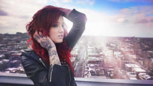 Red-haired Lady Showcasing Her Hand Tattoo Wallpaper