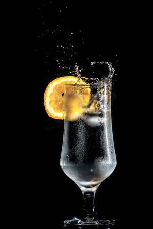 Refreshing Lemon Water On Black Background Wallpaper