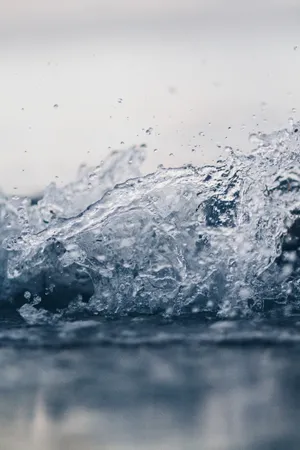 Refreshing Water Splashing Against Rock Wallpaper