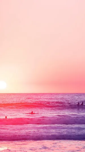 Relaxing At A Pink-hued Beach Wallpaper